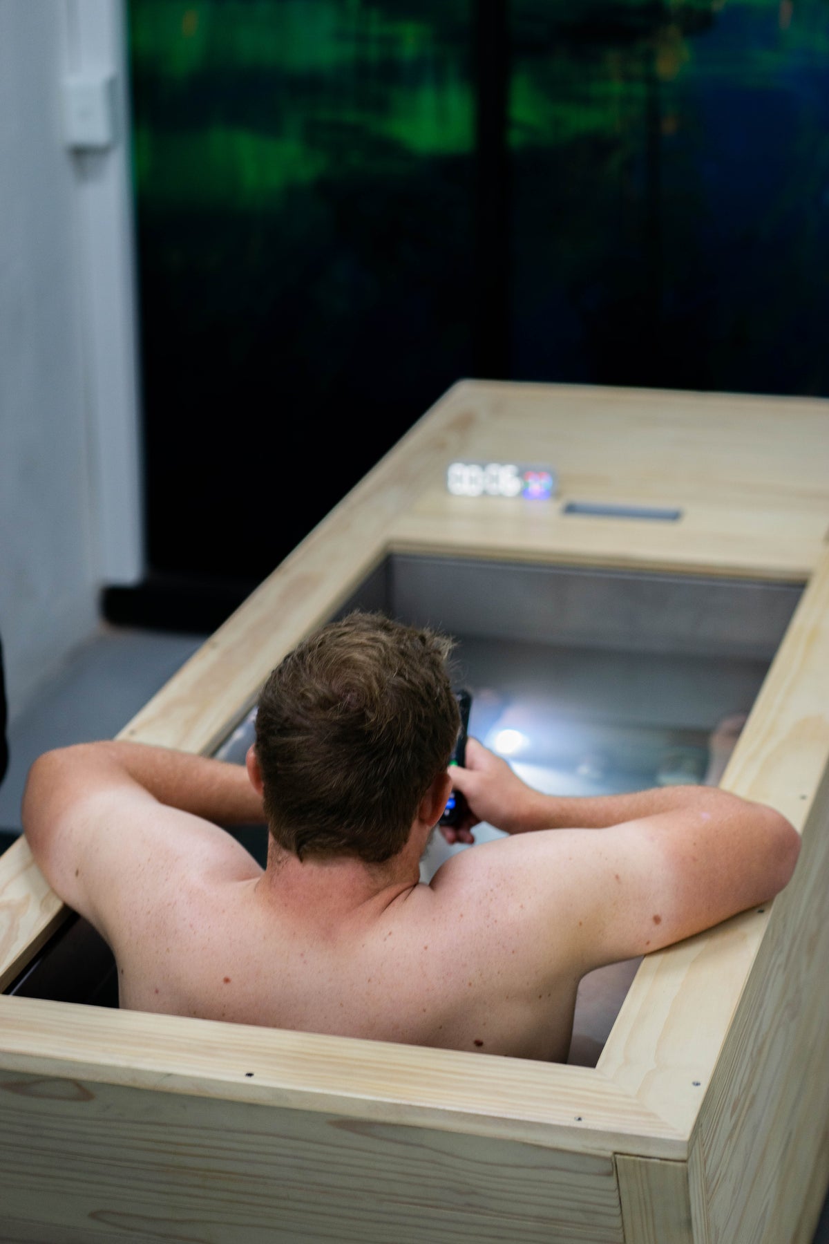 Rugby Player sitting in a renesis ice bath with a digital display